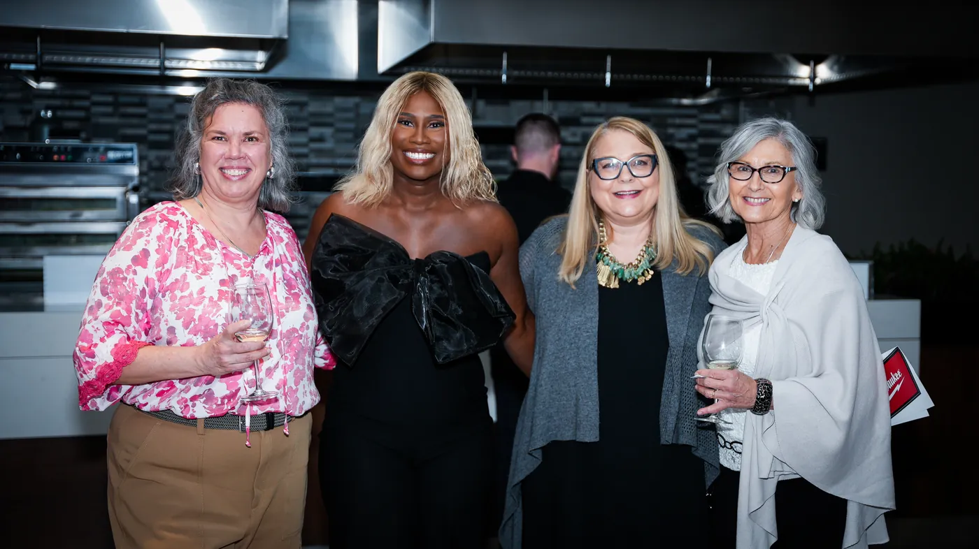 Four women standing together at a Women in Construction event